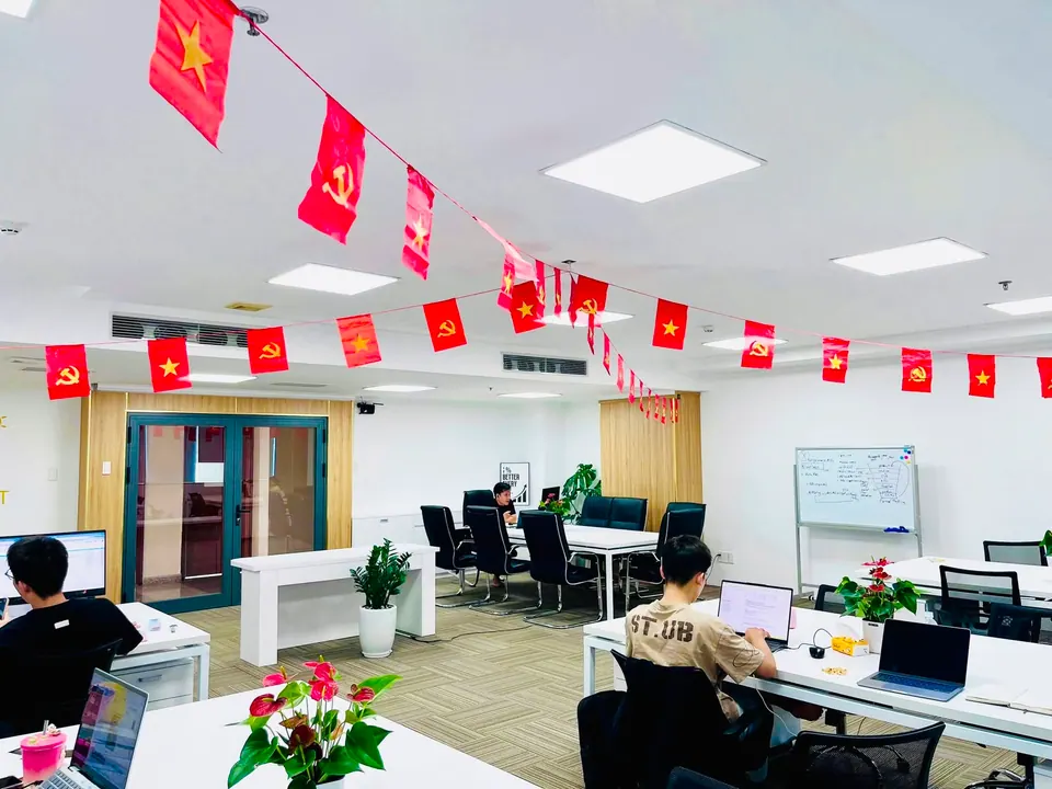 A corner of the LevelUp office, desks and plants by the window
