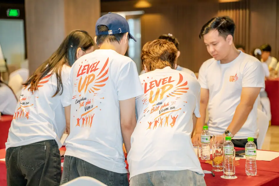 LevelUp team huddled over a whiteboard exercise in branded jerseys
